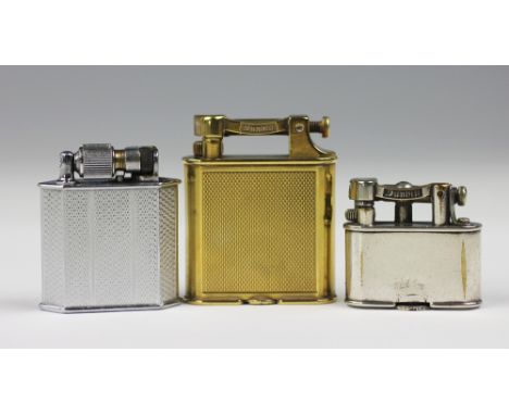 A Dunhill brass lighter, engine turned detail to the body, stamped to base 'Pat No 390107', 'Reg Des No 848767', 5.2cm high, 