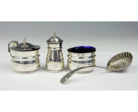 A silver three piece condiment set, William Aitken, Birmingham 1946, along with a silver sugar sifter spoon (5) 