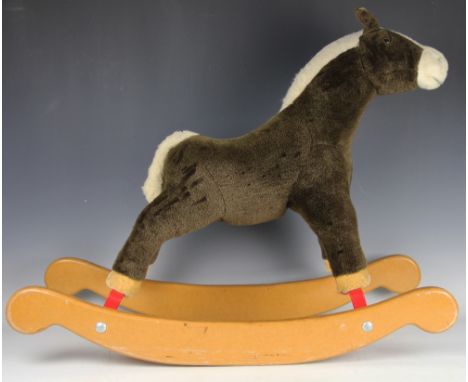 A 20th century Merrythought rocking horse made exclusivley for Harrods, bearing stitched label, 67cm high   