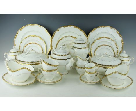 A Coalport Admiral pattern twelve place dinner service, each white glazed and with decorative scroll gilt border, comprising;