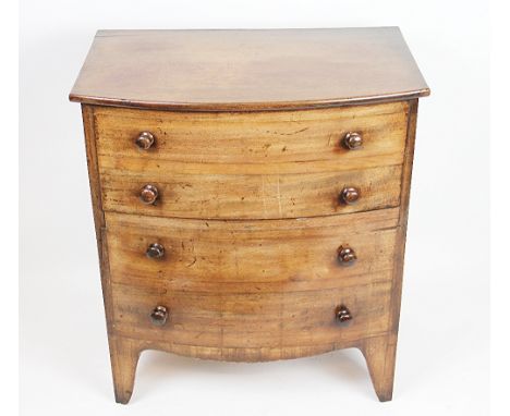 A Regency bow front mahogany bedside chest commode, with two dummy and two real drawers, on bracket feet, 68cm H x 61cm W x 3