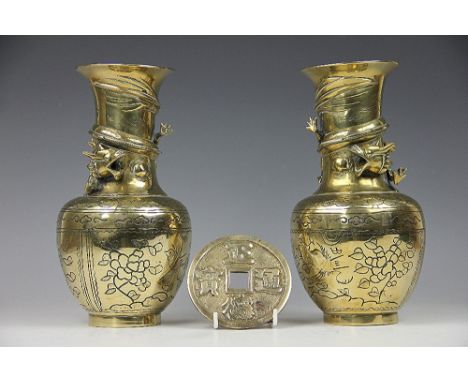 A pair of early 20th century Chinese brass vases, each baluster form vase applied with scrolling dragons above sgraffito pane