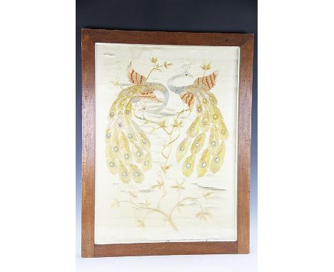 A Chinese silk embroidered panel depicting two peacocks upon entwined blossoming branches, 74cm H x 54cm W, framed and glazed