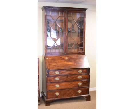 George III mahogany bureau bookcase, the upper section fitted three shelves, pigeon holes and three drawers enclosed by a pai
