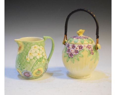 Burleigh Ware biscuit jar having floral decoration in relief, the cover having a butterfly finial, together with a Royal Wint