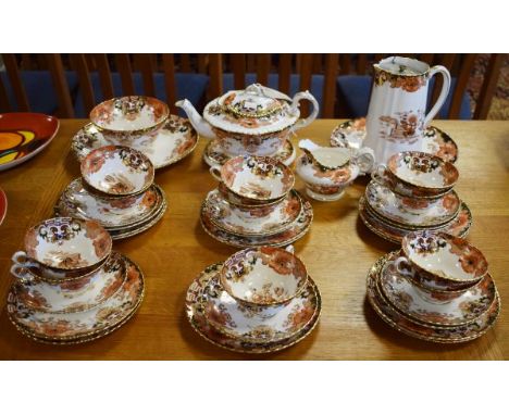Early 20th Century tea service having floral decoration in brown, orange and gilt   Condition: 