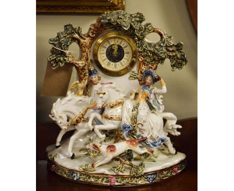 Porcelain framed mantel clock having figural decoration depicting a gallant and lady on horseback   Condition: 