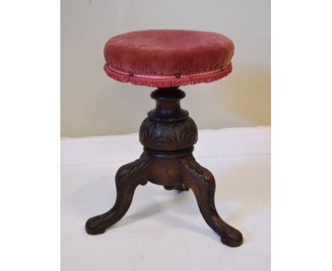 Victorian carved beech revolving piano stool standing on a turned pillar and tripod base   Condition: 