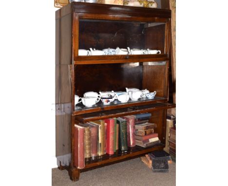 Mahogany and beech three tier sectional bookcase fitted two up-and-over doors and one open shelf   Condition: 