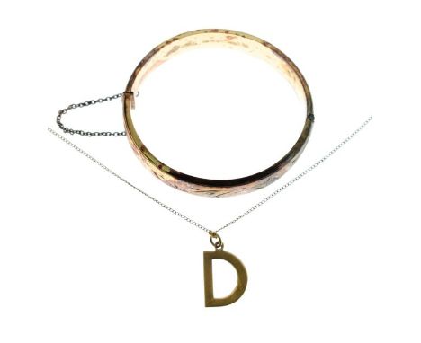 9ct gold pendant in the form of a D together with an engraved silver snap bangle   Condition: 