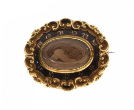 Victorian yellow metal and enamel mourning brooch having a central hair panel   Condition: 