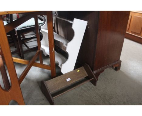 A white painted hanging shelf together with an oak book trough