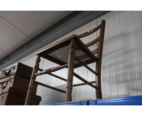 A cane seated ladder back chair 