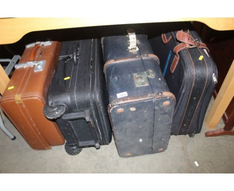 A wooden and metal bound travelling trunk and three suitcases