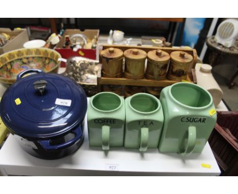 A quantity of spice jars contained on rack; three storage jars lacking covers and a Darntington casserole dish