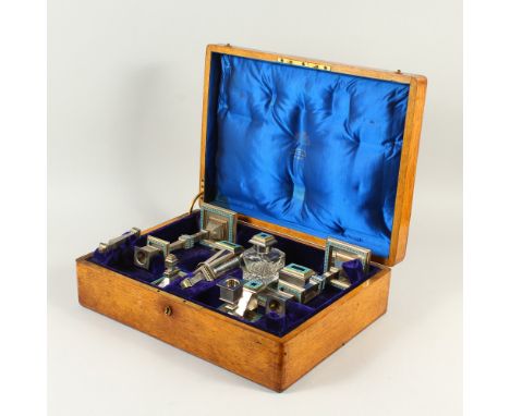 A SUPERB PAINTED ENAMEL DESK SET, by AUGUSTE KLEIN, PARIS, in an oak canteen, comprising large pair of candlesticks, 24cms hi