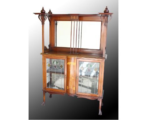 AN ART NOUVEAU MAHOGANY AND INLAID CABINET, with a mirrored back, over a central inlaid panel flanked by a pair of leaded, st