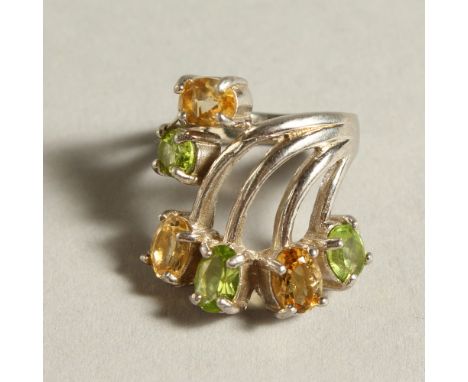 A SILVER, PERIDOT AND CITRINE RING.