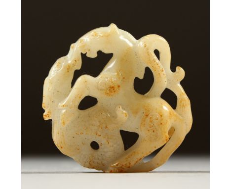 A PIERCED AND CARVED WHITE JADE PENDANT, carved as a horse and dragon. 5cms diameter.