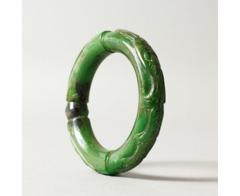 A DARK GREEN JADE BANGLE. 8cms diameter.
