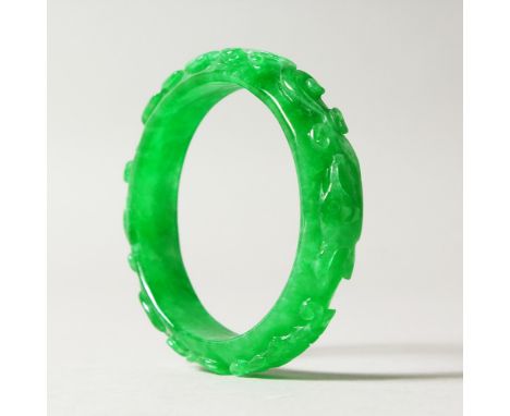 AN APPLE GREEN JADE BANGLE. 7.5cms diameter.