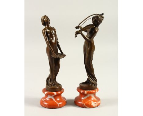 A PAIR OF ART NOUVEAU STYLE BRONZES OF YOUNG LADIES, on marble bases. 21cms high.