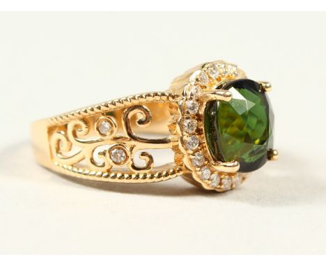 A 14K YELLOW GOLD AND DIAMOND RING, set with an oval cut green tourmaline approx. 2.95ct, diamonds approx. 0.25ct total weigh