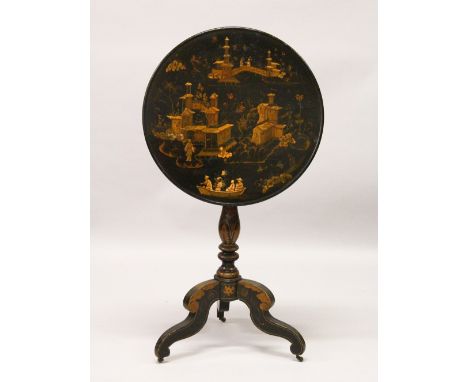 A 19TH CENTURY EBONISED CIRCULAR TILT TOP TRIPOD TABLE, with chinoiserie decoration. 74cm high x 55cm diameter.