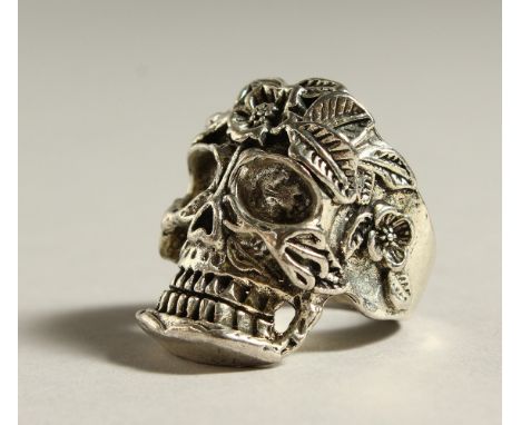 A SILVER SKULL RING.