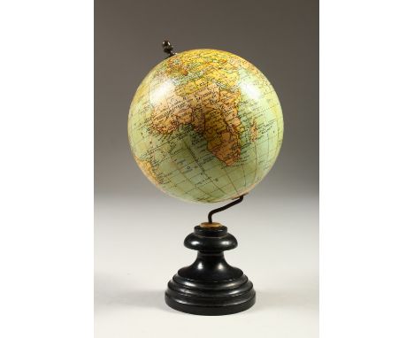 A SMALL GLOBE, on a turned wood stand. 20cms high.