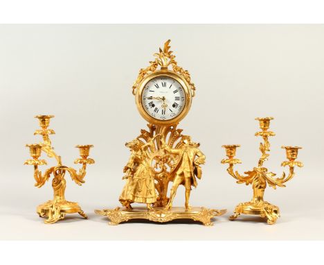 AN ITALIAN ORMOLU THREE PIECE CLOCK GARNITURE, the clock with circular enamelled dial, above a pair of figures, together with