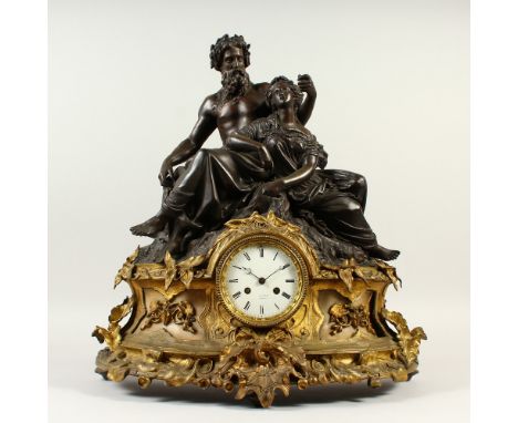 A 19TH CENTURY FRENCH ORMOLU AND SPELTER  MANTLE CLOCK, mounted with a male and female figure, the white enamel dial signed F