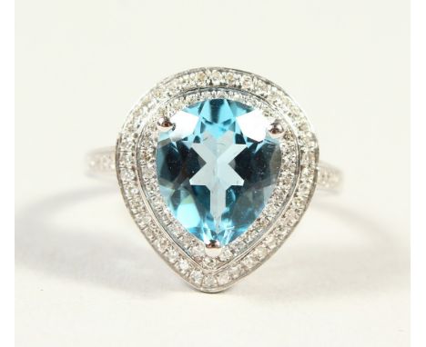 A 14K WHITE GOLD AND DIAMOND RING, set with a pear cut blue topaz approx. 4.42ct, diamonds approx. 0.60ct total weight.