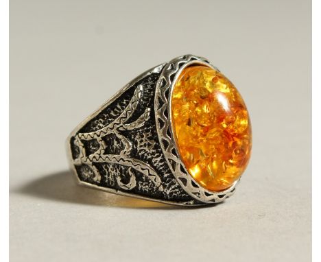 A SILVER AND AMBER RING.