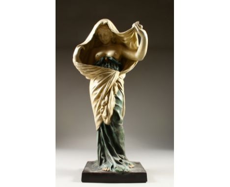 AN ART NOUVEAU STYLE POTTERY FIGURE OF A STANDING FEMALE SEMI NUDE. 63cms high.