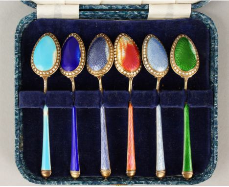 A SET OF SIX CASED SILVER AND ENAMEL SPOONS.