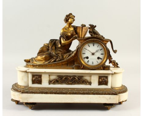 A 19TH CENTURY FRENCH ORMOLU AND MARBLE MANTLE CLOCK, mounted with a reclining female figure reading a book, the white enamel