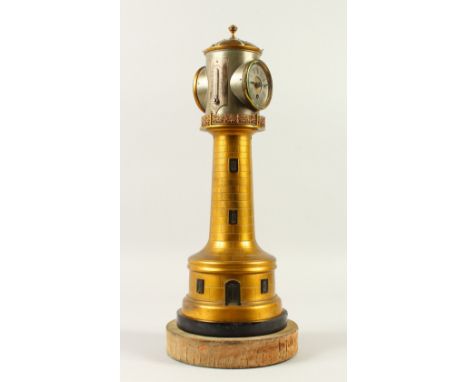AN EDWARDIAN LIGHTHOUSE COMBINATION CLOCK, BAROMETER AND THERMOMETER, on a circular base. 46cm high.