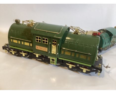 MTH 381E 3 rail tinplate standard gauge &nbsp;2 tone green train, together with a Lionel super motor 10E smaller loco on stan