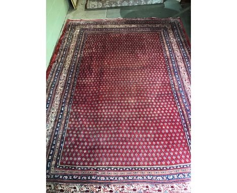 A Persian wool carpet 310cm x 215cm