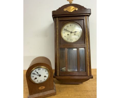 A mahogany wall clock, decorated with gilt decoration three bevelled glass panels also with an oak inlaid mantle clock.W:30cm