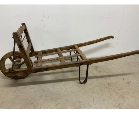 A vintage wooden wheelbarrow W:170cm x D:63cm x H:66cm