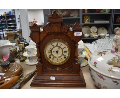 A vintage style bracket wall clock with mahogany styled case