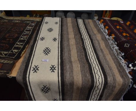 A hand woven light cream woolen blanket or throw