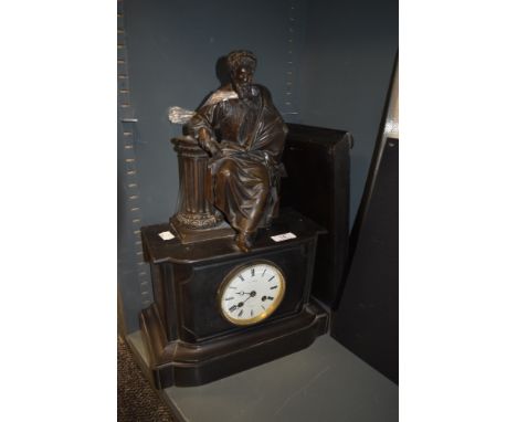 A Victorian slate cased American style mantle clock having bronze figure decoration sat atop