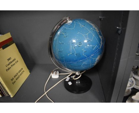 A mid century light up globe of the night sky or star charts