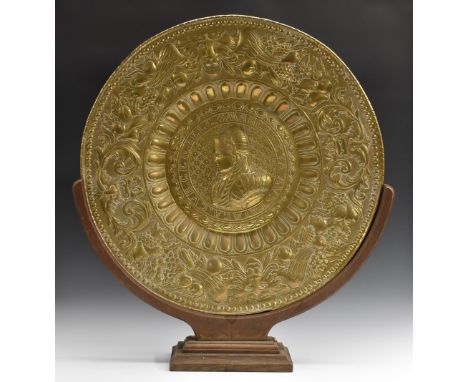 A substantial Renaissance Revival brass charger, embossed with a portrait of Margaret of Austria, Queen of Spain (1584 - 1611