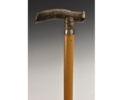 A Chinese silver mounted gentleman's walking cane, the serpentine L-shaped handle embossed with ferocious dragons, malacca sh