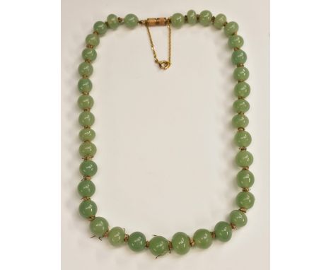 A string of Chinese pale green jade beads, 20cm drop
