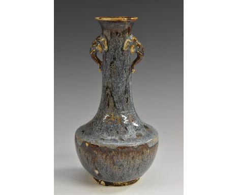 A Chinese Jun ware earthenware bottle vase, glazed in merging mottled tones of blue and purple, with some sallow inclusions, 